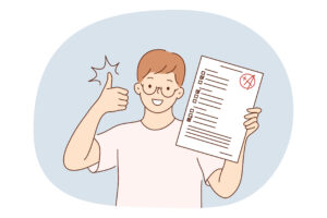 Happy student holding up a test paper with a top grade, giving a thumbs up.